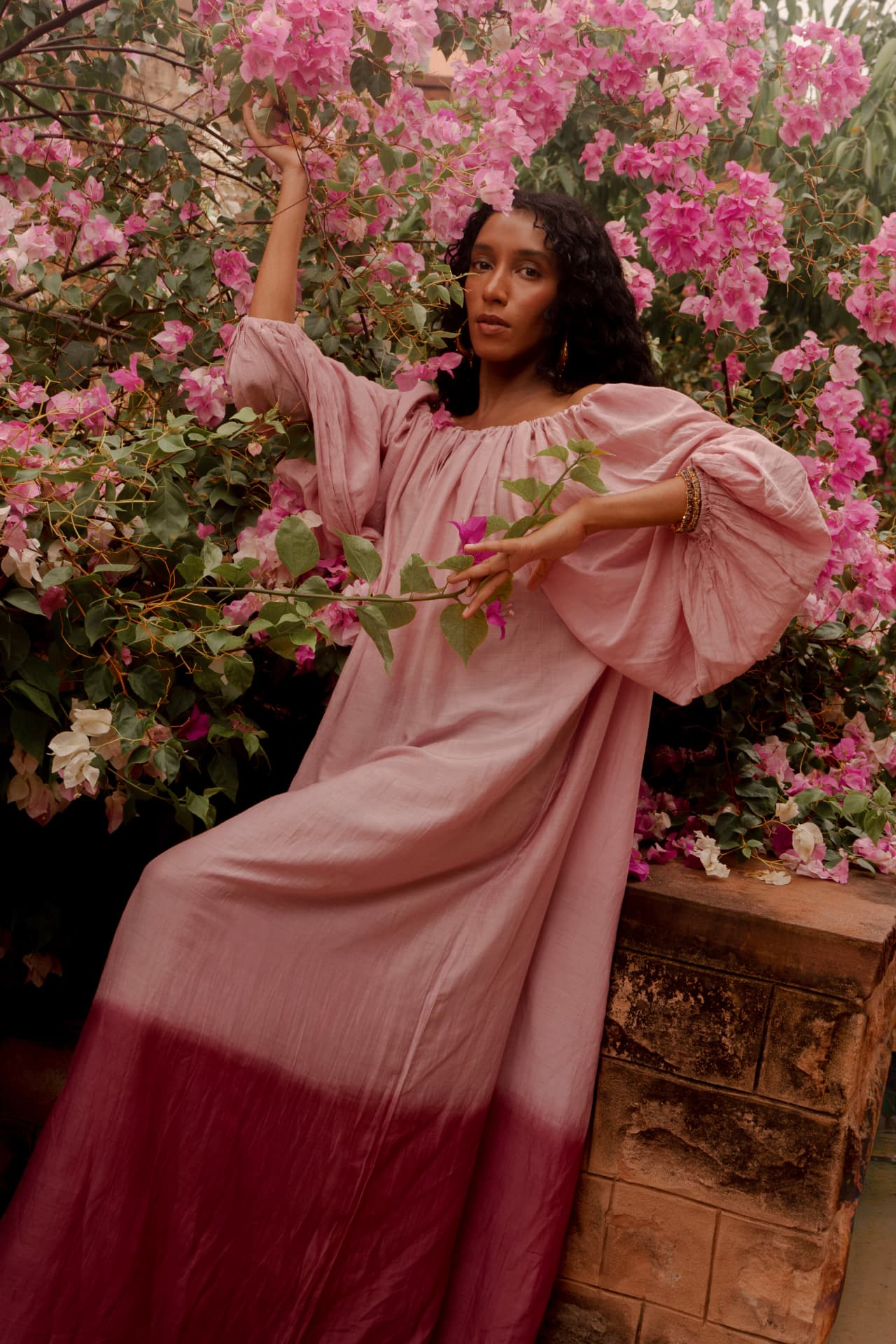 Radha dress in pink and berry ombre silk beneath a bougainvillea tree