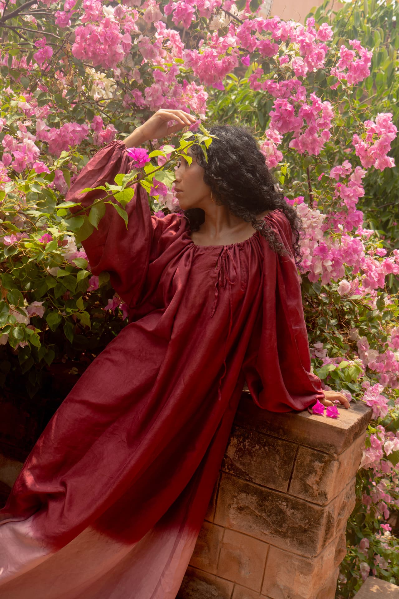 Radha dress in deep red mulberry silk among bougainvillea
