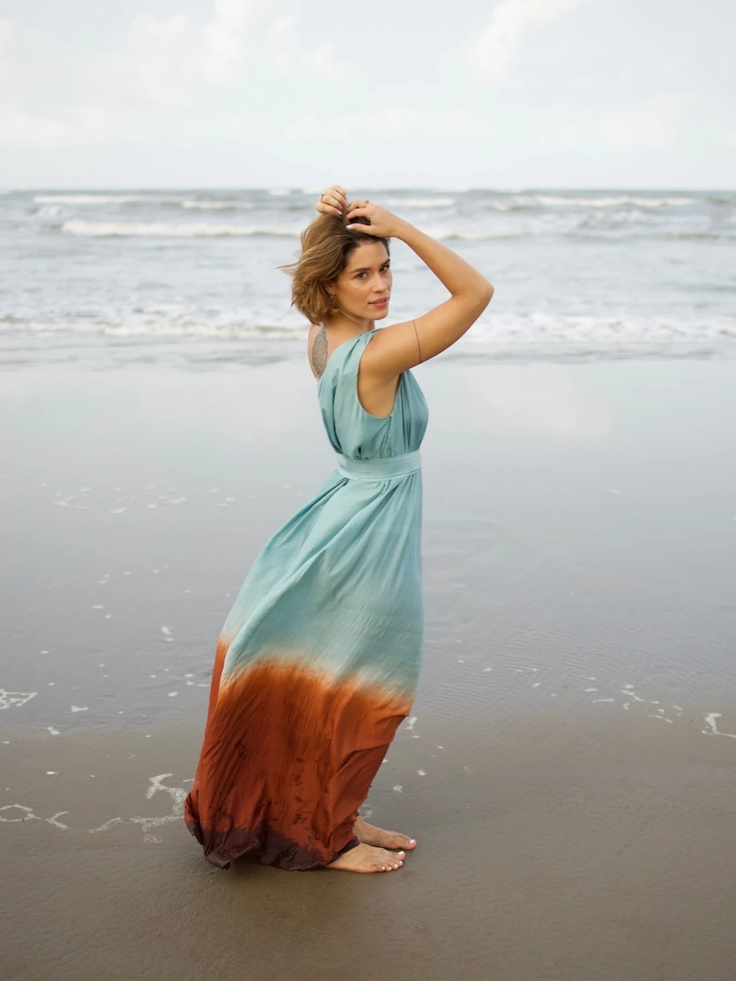 Aphrodite one-shoulder silk dress in blue on the shore