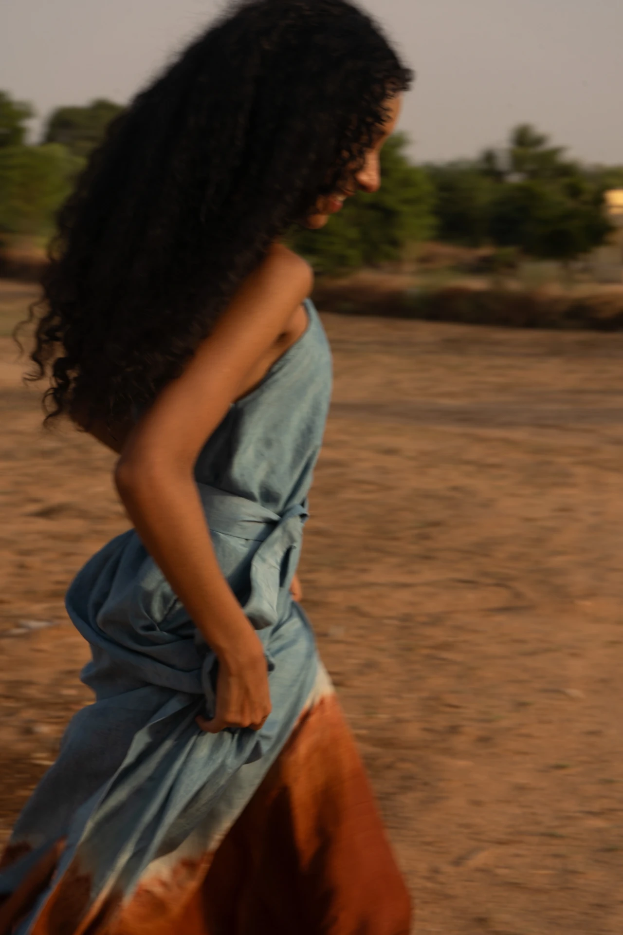 Blue mulberry silk dress in motion at golden hour